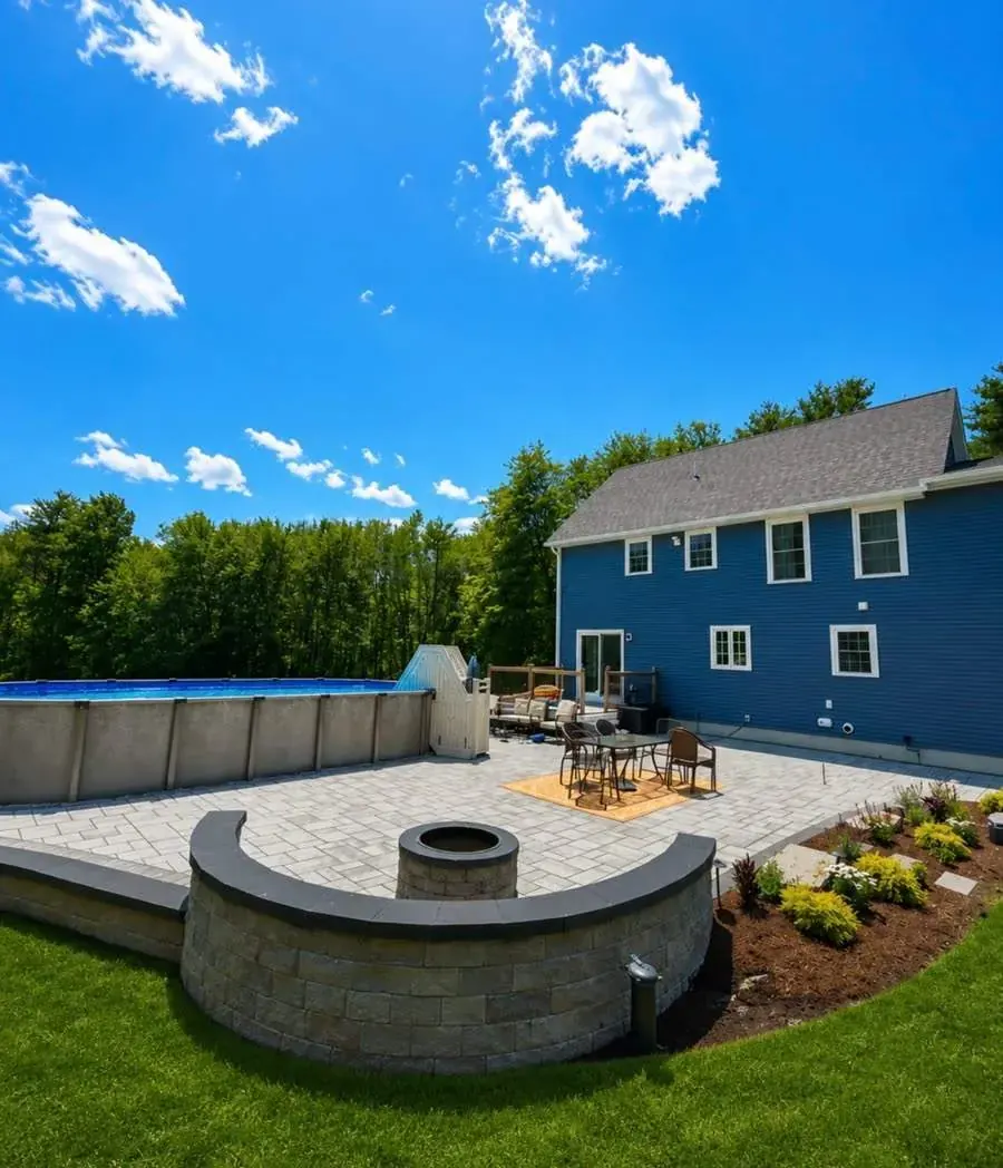 Pool patio with a seat wall and fire pit