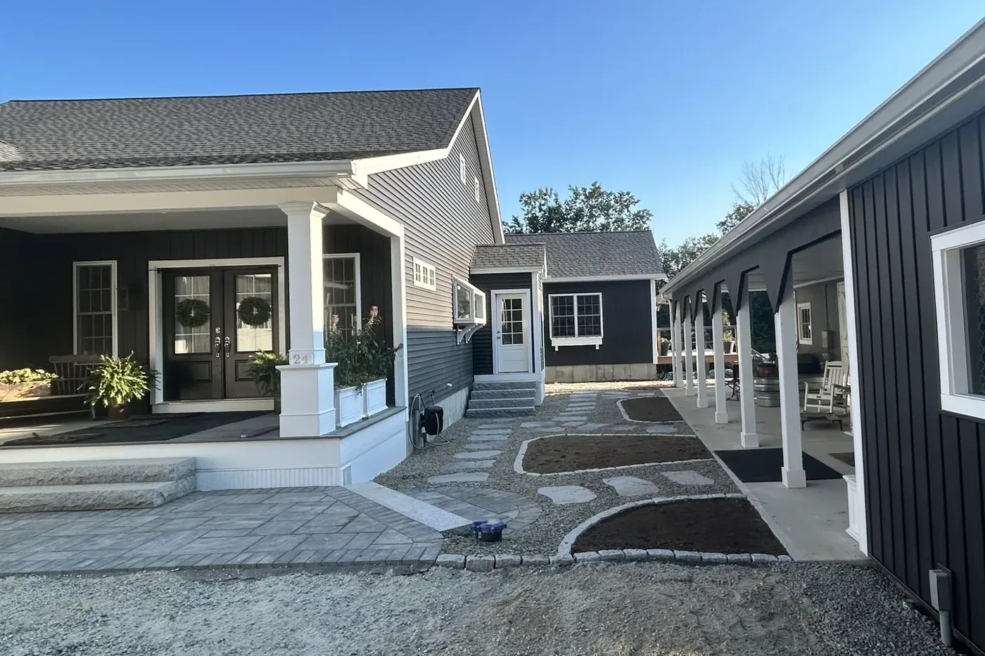 Paver walkway and patio finished along a new front porch